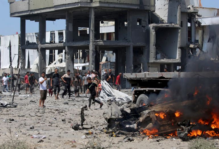 afp_6a8af5e9c68b-1787491817 Palestinians gather at the site following an Israeli strike, carried out after the military warned Palestinian residents to evacuate the area of Maghazi, in the central Gaza Strip, on August 23, 2026.