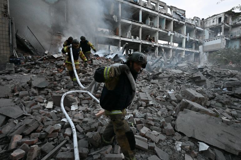 TOPSHOT - Firefighters work in a destroyed building of a research institute following an attack, which local Russian-installed officials called a Ukrainian strike, in Donetsk, Russian-controlled Ukraine, on August 26, 2026, amid the ongoing Russian-Ukrainian conflict. (Photo by STRINGER / AFP)