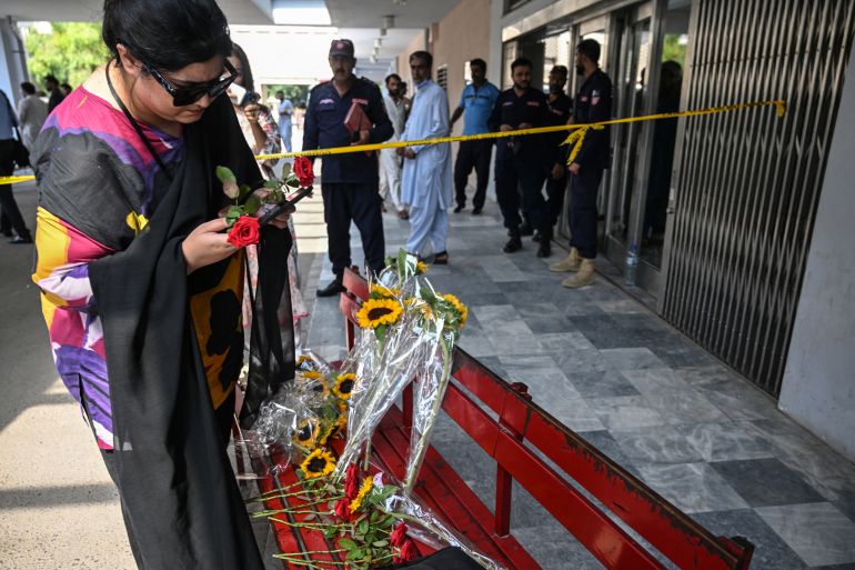 afp_6a940b24da53-1788087076 A woman places a flower outside the Mother and Child Health ward as she pays homage to infants killed in a fire at the Pakistan Institute of Medical Sciences (PIMS) Hospital in Islamabad on August 27, 2026.