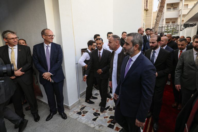 afp_6a949213c80b-1788121619 Libya's Tripoli-based Government of National Unity (GNU) Foreign Minister Taher al-Baour (centre, L) and Syria's interim foreign minister Asaad Shaibani (centre, R) arrive for the inauguration of Syria's embassy at Al-Nofleen district in Tripoli on August 30, 2026.