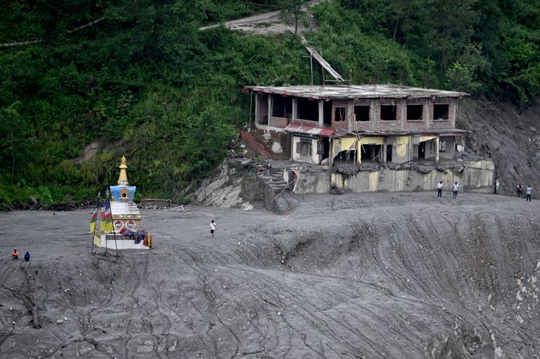 afp_6a95552335ed-1788171555 People visit a damaged Buddhist stupa after flash floods at Trishuli Center in Nepal's Nuwakot district on August 31, 2026.