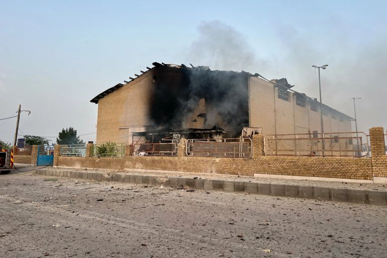 Smoke rises from a building damaged in a strike in Lamerd, southern Iran, February 28, 2026. (Alireza Ameri/Tasnim News Agency via AP)