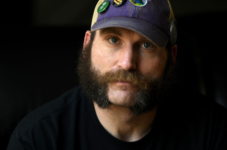 ap26218015739344-1786047643 Joe Shearer, who was diagnosed with traumatic brain injuries from fighting in Iraq, poses for a portrait in his home in Colorado Springs, Colo., Wednesday, Aug. 5, 2026. (AP Photo/Thomas Peipert)