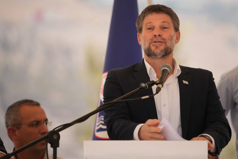 CORRECTS DAY Israeli Finance Minister Bezalel Smotrich speaks to journalists during a press conference about new settlement construction in the Israel-occupied West Bank near Maale Adumim, Thursday, Aug. 14, 2025. (AP Photo/Ohad Zwigenberg)