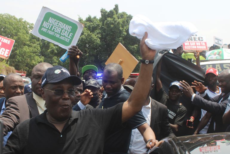 Atiku Abubakar of the Peoples Democratic Party and second place candidate, greets his supporters during a protest against the recent presidential election results, in Abuja , Nigeria, Monday, March 6, 2023. Thousands of opposition supporters staged a protest Monday against the country’s presidential election results, as calls for a revote intensified. (AP Photo/Gbemiga Olamikan)