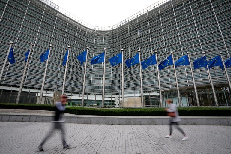ap_6a5e2a97a66ae-1784556183 FILE - European Union flags flap in the wind as pedestrians walk by EU headquarters in Brussels, Wednesday, Sept. 20, 2023. (AP Photo/Virginia Mayo, File)