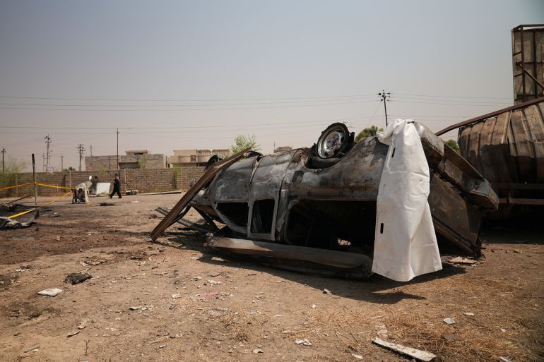 ap_6a6e7b51e142e-1785625425 A damaged vehicle at the site of an airstrike on a Popular Mobilization Forces base in Mosul, Iraq, Wednesday, July 29, 2026. (AP Photo/Farid Abdulwahed)