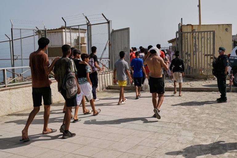 ap_6a6ee5e272d87-1785652706 Migrants who crossed into Spain return to Morocco from the Spanish enclave of Ceuta, Saturday, Aug. 1, 2026. (AP Photo/Bernat Armangue)