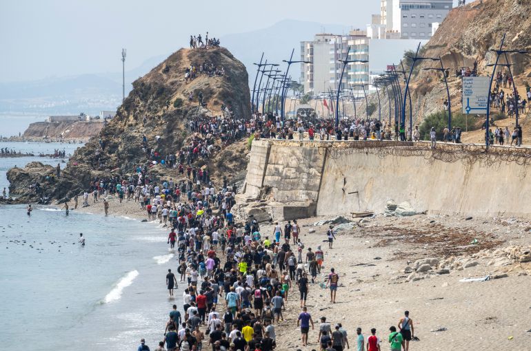 ap_6a6f2ef35f474-1785671411-1 People walk on a beach after attempting to cross from the Moroccan northern town of Fnideq to the Spanish enclave of Ceuta, Friday, July 31, 2026. (AP Photo)