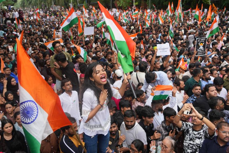 ap_6a71a0e2dd038-1785831650 FILE- Protesters celebrate after Education Minister Dharmendra Pradhan resigned following nationwide protests as part of the Cockroach Janta Party's protest movement in Mumbai, India, Sunday, July 26, 2026. (AP Photo/Rafiq Maqbool, File)