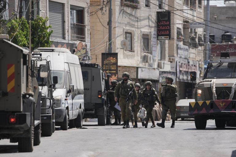 ap_6a752a1f26590-1786063391 Israeli army units are deployed during an army operation in the West Bank refugee camp of Qalandiya, Thursday, Aug. 6, 2026. (AP Photo/Mahmoud Illean)