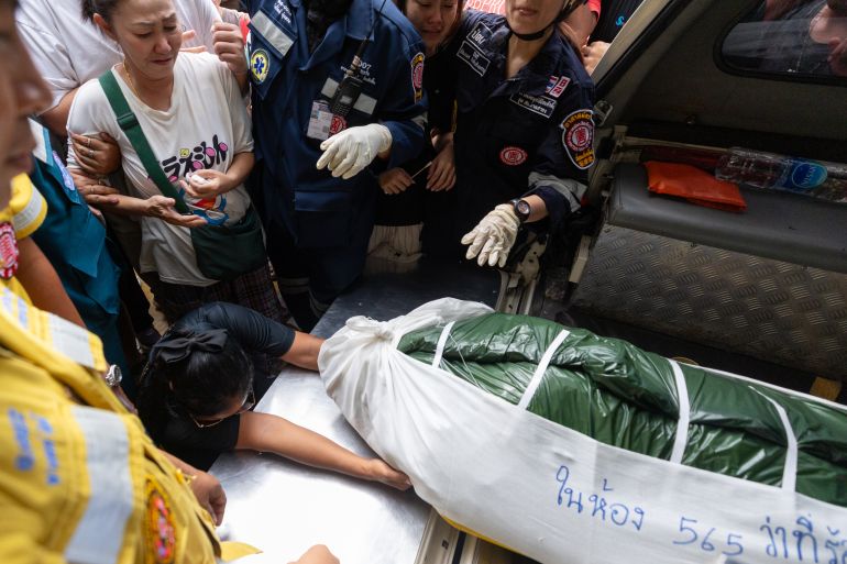 A woman weeps beside the body of a victim of a school shooting in Thailand's Nonthaburi province, Friday, Aug. 7, 2026. (AP Photo/Wason Wanichakorn)