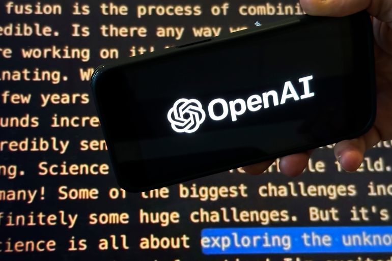 ap_6a770a4bad198-1786186315-1 File - The OpenAI logo appears on a mobile phone in front of a screen showing part of the company website in this photo taken on Nov. 21, 2023 in New York. Negotiators will meet this week to hammer out details of European Union artificial intelligence rules but the process has been bogged down by a simmering last-minute battle over how to govern systems that underpin general purpose AI services like OpenAI's ChatGPT and Google's Bard chatbot. (AP Photo/Peter Morgan, File)