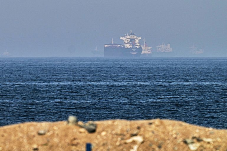 ap_6a77541846d49-1786205208-1 FILE - Cargo ships are seen at sea near the Strait of Hormuz, as viewed from a rocky shoreline near Khor Fakkan, United Arab Emirates, Friday, May 1, 2026. (AP Photo/Fatima Shbair, File)