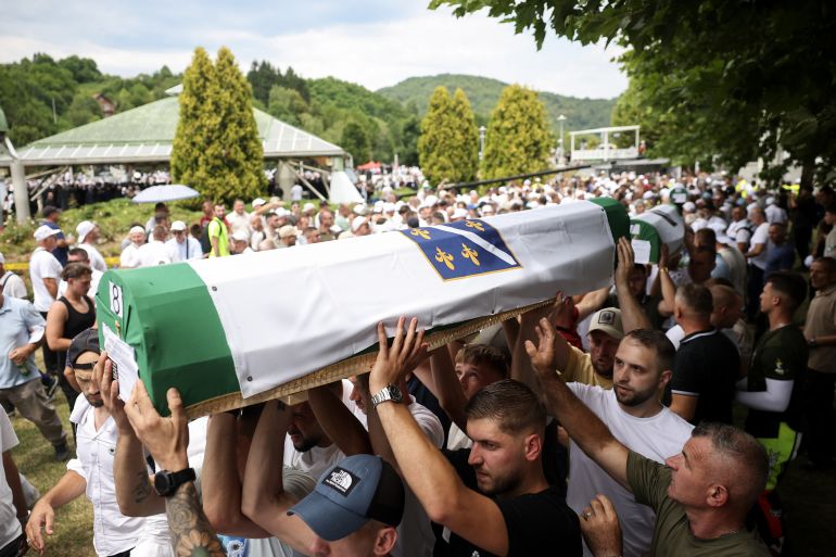 ap_6a90775aa74c6-1787852634 Bosnian Muslims carry coffins containing remains of 10 newly identified victims of Srebrenica genocide during a mass burial ceremony in Potocari, Bosnia, Saturday, July 11, 2026. (AP Photo/Armin Durgut)