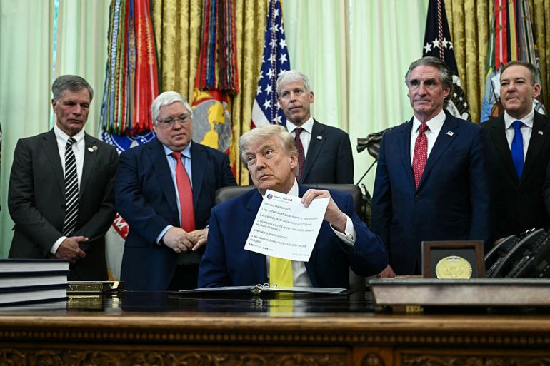 as62d-1786004937 US President Donald Trump holds a printed copy of a post from his Truth Social account about "The Safeguard American Voter Eligibility Act" (also known as the "SAVE America Act") as he speaks in the Oval Office of the White House in Washington, DC on June 4, 2026. (Photo by Brendan SMIALOWSKI / AFP via Getty Images)