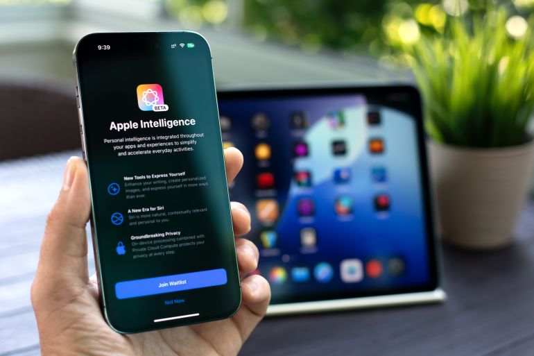 Alanya, Turkey - July 31, 2024: Man hand holding Apple iPhone 15 Pro Max and iPad with home screen IOS 18 AI Apple Intelligence Siri on the screen.