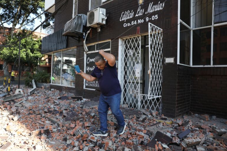 download-13-1786438623 A man leaves an apartment building after an earthquake struck Cali, Colombia, Monday, Aug. 10, 2026. (AP Photo/Santiago Saldarriaga)
