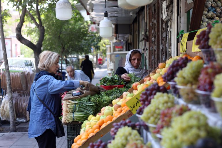 epa_6a8b1e81680c-1787502209 epa13183888 An Iranian woman buys vegetables at a street market in Tehran, Iran, 22 August 2026. US President Donald Trump said the US will launch 'economic D-Day' sanctions against Iran, which he called the 'most crushing economic operation ever taken against any country,' as the Iran and US conflicts continue. EPA/ABEDIN TAHERKENAREH RESTRICTIONS: NO Access Israel Media/Persian Language TV Stations Outside Iran/Strictly No Access BBC Persian/VOA Persian/Manoto TV/Iran International TV. (As mandated by Iran's Directorate General for Foreign Media) --