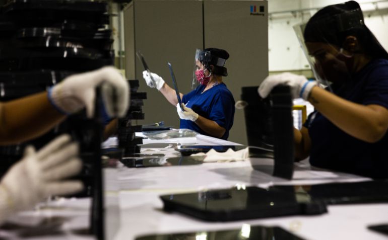 getty_6970d6921f-1769002642 OSASCO, BRAZIL - APRIL 30: Workers assemble face shield masks on April 29, 2020 in Osasco, Brazil. Ambev partnered with Bizsys to produce face shield masks with the same material as the PET bottle of Guarana Antarctica (one of Ambev's most famous soft drinks in Brazil) that is already cut into sheets. The face shield masks will been donated to health professionals in public and private hospitals in the fight against coronavirus (COVID-19) pandemic. Ambev was born in 1999 from the merger between the centenarians 'Cervejaria Brahma' and 'Companhia Antarctica'. Interbrew from Belgium and Ambev merged to create InBev. Belgium-Brazilian InBev acquired Anheuser-Busch from the United States creating the world biggest brewer. (Photo by Alexandre Schneider/Getty Images)
