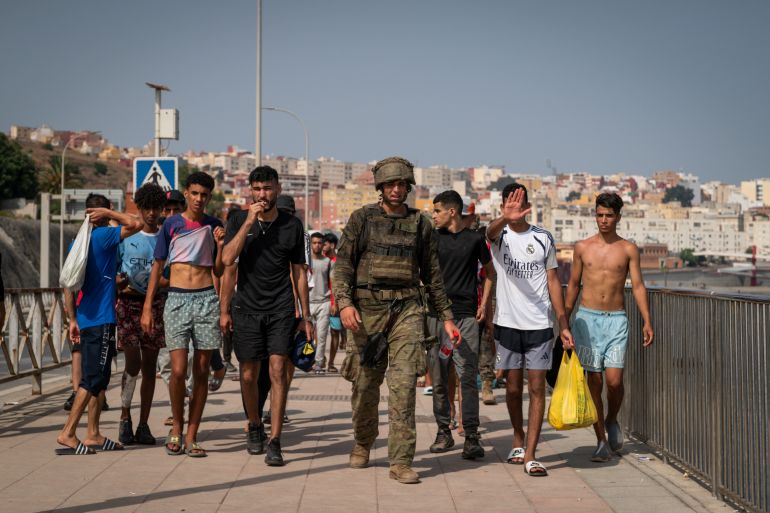 getty_6a6ee58551-1785652613 CEUTA, SPAIN - AUGUST 1: Migrants are crossing back to Morocco on the border with Spain on August 1, 2026 in Ceuta, Spain. Spain's interior ministry has said it's deploying 60 members of the armed forces and an additional 30 Guardia Civil officers to Ceuta after tens of thousands of migrants entered the Spanish enclave in North Africa on Thursday. A large number of people swam through the Tarajal breakwater to enter the Spanish territory from neighboring Morocco, while others scaled the border fence. Some estimates have said that around 49,000 migrants made the crossing, with the surge of arrivals overwhelming migrant reception centres, with many sleeping on the streets overnight. (Photo by Adri Salido/Getty Images)