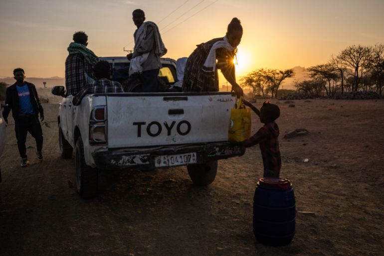 TIGRAY, ETHIOPIA - FEBRUARY 19: People unload belongings from a pickup truck at a checkpoint at dawn on the outskirts of Yechila town in the Yechila district on February 19, 2024 in Tigray Region, Ethiopia. More than 20 million Ethiopians are in need of food aid, according to estimates from the UN's Office for the Coordination of Humanitarian Affairs (UNOCHA). The situation is particularly acute in drought-stricken Tigray, in the country's north, which is still recovering from a two-year war between the Ethiopian government and allied forces on one side, and Tigrayan forces on the other, during which the region's economy was devastated and many were displaced. The combined effects of war and drought have raised the specter of famine, which the federal government in Addis Ababa denies is imminent, saying it is committed to providing aid. (Photo by Ed Ram/Getty Images)