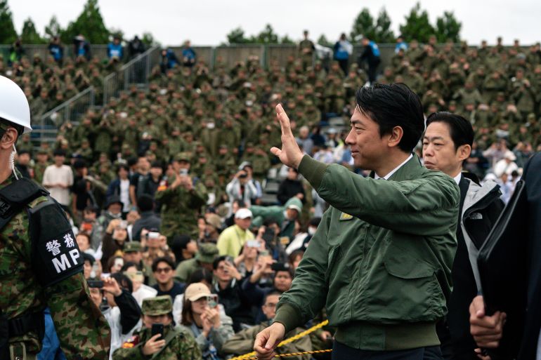 GOTEMBA, JAPAN - JUNE 07: Japanese Defense Minister Shinjiro Koizumi waves as he leaves a live-fire exercise held by the Japan Ground Self-Defense Force (JGSDF) at the East Fuji Maneuver Area on June 07, 2026, in Gotemba, Shizuoka Prefecture, Japan. Japan lifted its ban on exporting lethal weapons in April, reversing the nation's postwar policy, while defense-related spending reached a record 9.04 trillion yen in the fiscal 2026 budget, up 3.8 percent from the previous fiscal year and marking a record high for the 12th consecutive year. (Photo by Tomohiro Ohsumi/Getty Images)