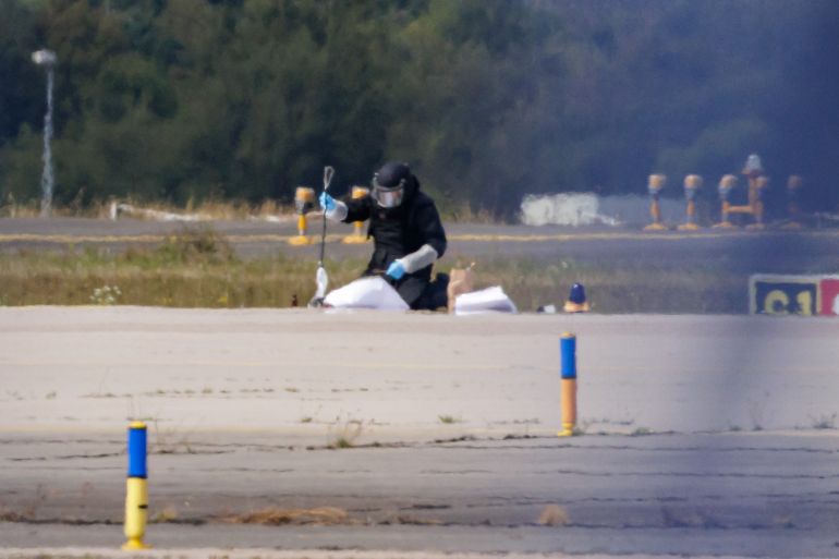 getty_6a73c96770-1785973095 LEIPZIG, GERMANY - AUGUST 5: A Police investigator works on the tarmac at Leipzig/Halle Airport on August 5, 2026 near Leipzig, Germany. Airport workers reportedly discovered a drone yesterday on the tarmac near a Ukrainian Antonov cargo plane that was equipped with an explosives detonator and an unidentified substance. Additionally, a DHL cargo plane that took off from the airport late last night collided with a small object, causing minor damage. (Photo by Jens Schlueter/Getty Images)