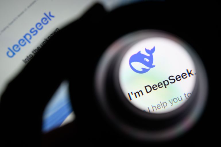 getty_6a770ba0c3-1786186656 LONDON, ENGLAND - JANUARY 29: In this photo illustration, the Deepseek logo is seen through a magnifying loupe while displayed on a mobile phone screen on January 29, 2025 in London, England. This week's news that the DeepSeek Chatbot app, developed by China, was downloaded from the Apple app store significantly more times than the US-developed ChatGPT from Open AI, wiped billions off the global tech market. The advent of DeepSeek has shown there is a more viable, efficient, and cost-effective future for AI development in a shift away from the current high cost, high tech model. (Photo by Leon Neal/Getty Images)