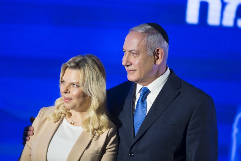 getty_6a77ac71a8-1786227825 RAMAT GAN, ISRAEL - DECEMBER 02: (ISRAEL OUT) Israeli Prime Minister Benjamin Netanyahu (R) stands by his wife Sara before lighting a stylised-menorah during the start of Hanukkah, the Jewish festival of lights on December 2, 2018 in Ramat Gan, Israel. Earlier today, police and Israel Securities Authority recommended indicting Netanyahu and his wife, Sara, for bribery and other corruption charges. (Photo by Lior Mizrahi/Getty Images)