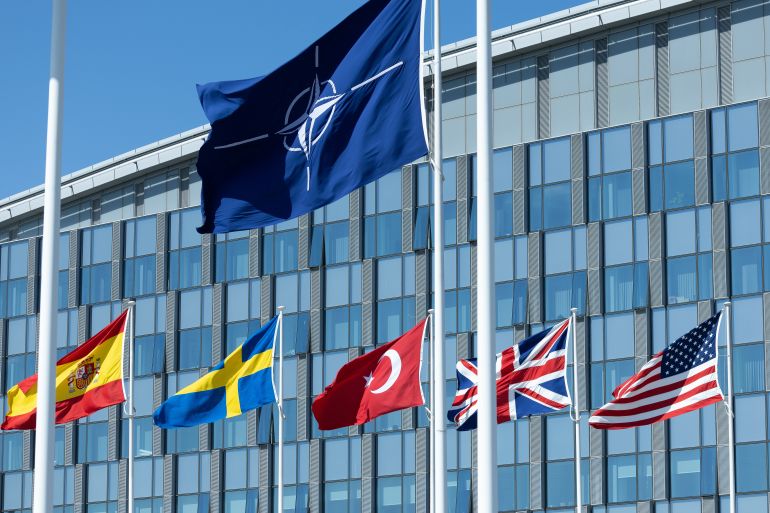 getty_6a78508e6f-1786269838 BRUSSELS, BELGIUM - APRIL 04: The NATO flag is seen in the centre among the flags of the NATO member countries at the NATO headquarters building on April 04, 2025 in Brussels, Belgium. NATO Foreign Ministers are gathering in Brussels for a two-day summit to discuss security priorities, including defense investment and solutions to reaching a lasting peace for Russia's war in Ukraine. The summit comes amid fresh tensions between the US and NATO allies over the policies of US President Donald Trump, including a new raft of tariffs announced on Wednesday. (Photo by Omar Havana/Getty Images)