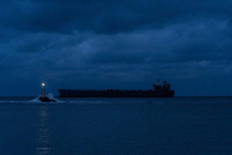 getty_6a7f64c450-1786733764 AHTOPOL, BULGARIA - DECEMBER 8: The Kairos oil tanker, a Gambian-flagged vessel believed to be part of Russia's shadow fleet, remains anchored on December 8, 2025 in Ahtopol, Bulgaria. Last week, the ship was sailing from Egypt toward the Russian port of Novorossiysk when it caught fire after an alleged attack by Ukrainian naval drones. Bulgarian maritime authorities are planning the evacuation of the remaining crew. The tanker was sanctioned by the European Union in July for its involvement in Russia's so-called shadow fleet, a clandestine network of vessels that help the country skirt price-capping sanctions on Russian oil sales, penalties that were imposed after the 2022 invasion of Ukraine. (Photo by Hristo Rusev/Getty Images)