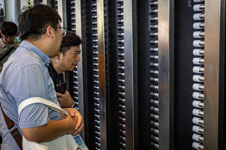 TAIPEI, TAIWAN - JUNE 02: Attendees closely examine a server rack system equipped with cooling components at a hardware exhibition booth during COMPUTEX on June 02, 2026 in Taipei, Taiwan. Running June 2–5 across four venues in Taipei's Nangang and Xinyi districts under the theme "AI Together," the annual trade show has drawn more than 1,500 exhibitors and industry heavyweights including NVIDIA CEO Jensen Huang to showcase next-generation AI chips, robotics, and computing infrastructure, cementing Taiwan's role as the world's pre-eminent hub for semiconductor and AI supply chain innovation. (Photo by Cheng Chia Huang/Getty Images)