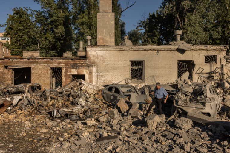 getty_6a8ad05a55-1787482202 KYIV, UKRAINE - AUGUST 20: Residents walk through debris in a courtyard following a Russian missile strike on August 20, 2026 in Kyiv, Ukraine. Apartment blocks and warehouses were hit across the city overnight following a large barrage of missiles, with a children's hospital and school also damaged (Photo by Diego Fedele/Getty Images)