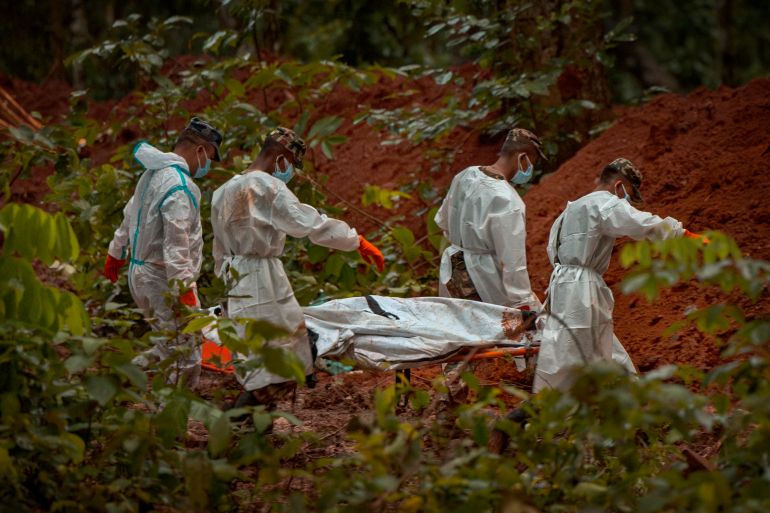 BHARATPUR, NEPAL - AUGUST 30: (EDITOR'S NOTE: Image depicts death.) Police and army personnel bury unidentified bodies recovered from the flash floods at a mass burial site in the Devghat Forest on August 30, 2026 in Bharatpur, Nepal. Authorities said the flash floods were triggered after a mass of ice, mud and rock collapsed into a Himalayan river near the Nepal-China border, leaving hundreds dead or missing and causing widespread damage in affected districts. Authorities continued the gruelling search for victims, many buried under metres of mud, as both China and Nepal issued fresh flooding alerts. (Photo by Ezra Acayan/Getty Images)