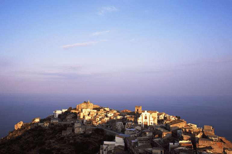 taly, Sicily, Messina, Forza d'Agro, elevated view over the town at sunset, best known as one of the locations for the Godfather movies
