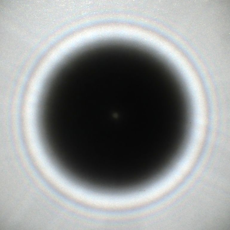 la-1785312151 Photo of the Arago spot in a shadow of a 5.8 mm circular obstacle.Aleksandr Berdnikov - Own work The shadow of a circular obstacle (5.8 mm) in diameter lit by a ~0.5 mm sunlight source, exposing the Arago spot in the middle of a shadow. Distance from the light source to the obstacle 5 ft (~153 cm), distance from the obstacle to the paper screen 6 ft (~183 cm). CC BY-SA 4.0 File:A photograph of the Arago spot.png Creat