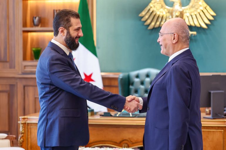 pic-8874444-1786662487 برهم صالح وأحمد الشرع This handout picture released by the official Syrian Arab News Agency (SANA) shows President Ahmad al-Sharaa (L) shaking hands with the United Nations High Commissioner for Refugees (UNHCR) Barham Salih, and his accompanying delegation, at the Peoples Palace in Damascus on August 10, 2026. (Photo by SANA / AFP) / == RESTRICTED TO EDITORIAL USE - MANDATORY CREDIT "AFP PHOTO / HO / SANA" - NO MARKETING NO ADVERTISING CAMPAIGNS - DISTRIBUTED AS A SERVICE TO CLIENTS ==
