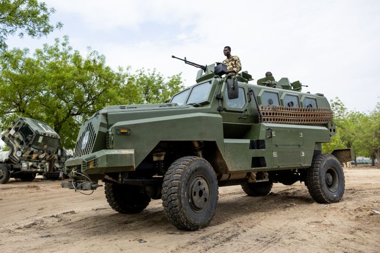 pic-887744115-1778943729 Nigerian soldiers from the Multinational Joint Task Force (MNJTF) drive an armoured truck at the MNJTF military base, Sector 3 Headquarters, in Monguno, Borno state, Nigeria, on July 5, 2025. Twelve checkpoints manned by the Nigerian army control the various entrances to Monguno. Monguno's huge fortifications have kept the garrison town mostly secure even as northeastern Nigeria has seen a recent surge in attacks on military bases by jihadists fighting a grinding 16 year war. Fighting in Borno may have eased since the conflict's highpoint in 2015 as jihadists have been forced back. But militants from Islamic State West Africa Province or rival Boko Haram have attacked or temporarily overrun a dozen military bases since the start of the year. (Photo by Joris Bolomey / AFP)