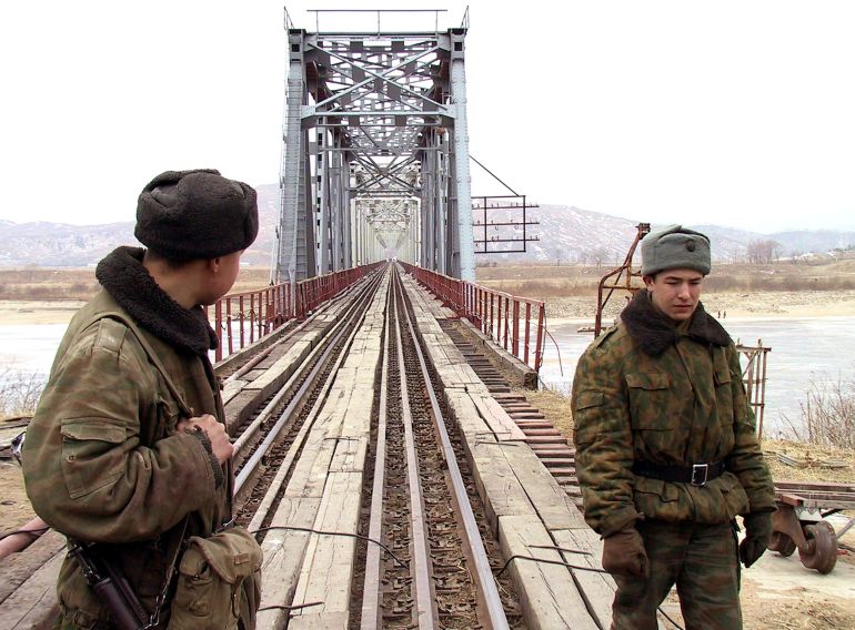 pic-88988441-1786298590 Russian soldiers patrol by the Druzhby bridge (Bridge of Friendship) that straddles the country's border with North Korea, January 26, 2003. Russia, the only member of the Group of Eight industrial countries to have warm relations with both Koreas, has been urging Pyongyang to find a diplomatic solution to its dispute with the United States. Picture taken January 26, 2003. REUTERS/Igor Onuchin AS