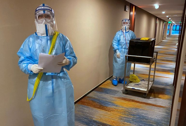 reuters_696f53ee-1768903662 Medical workers wearing personal protective equipment clothing (PPE) walk in the corridor of a hotel being used as an isolation centre for visiting Olympic personnel testing positive for COVID-19, as the coronavirus disease pandemic continues, during the Beijing 2022 Winter Olympics in Beijing, China, February 17, 2022. REUTERS/Toby Melville