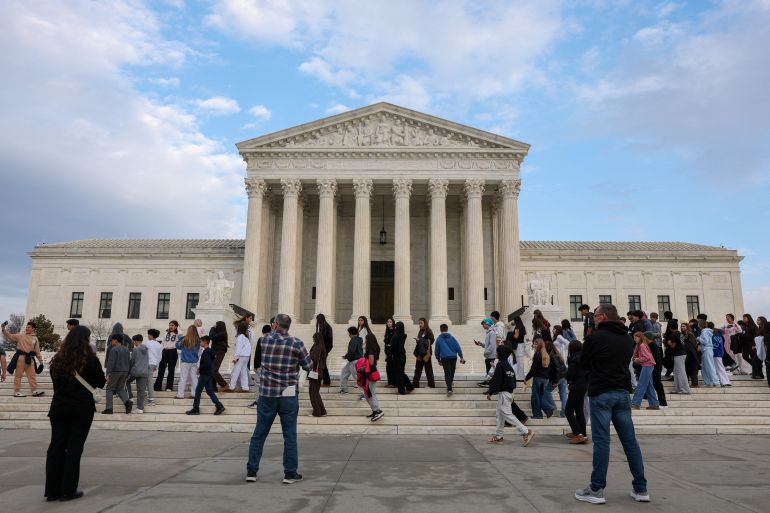 reuters_69a09953-1772132691 People walk near the U.S. Supreme Court, where justices are expected to issue opinions in pending cases, in Washington, D.C., U.S., February 25, 2026. REUTERS/Kylie Cooper