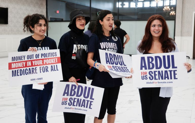 reuters_6a707bfd-1785756669 Supporters of U.S. Senate Democratic candidate Abdul El-Sayed pose with campaign signs during a rally in Dearborn, Michigan, U.S., July 31, 2026. REUTERS/Rebecca Cook