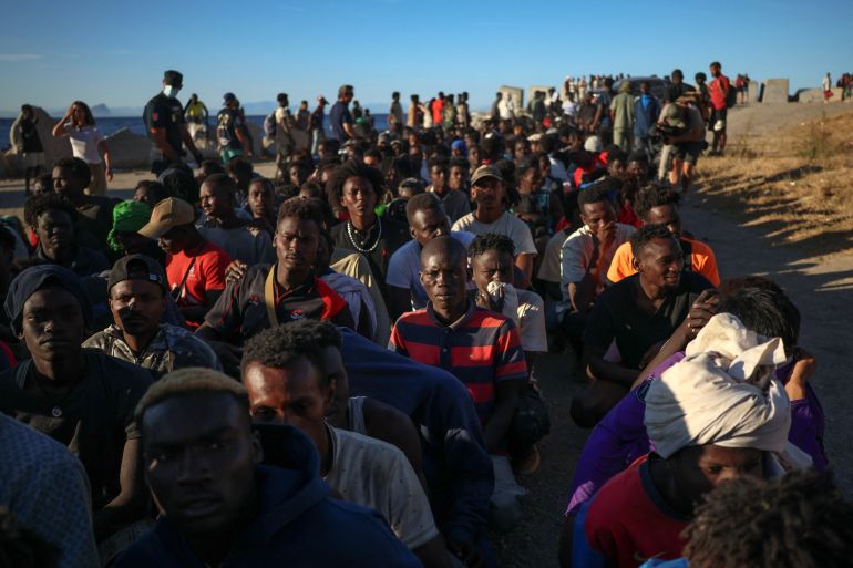 reuters_6a710aee-1785793262 Migrants wait in line to receive food and beverage from the Red Cross, following mass crossings of migrants on foot and by sea from Morocco into Spanish territory, in Ceuta, Spain, August 3, 2026. REUTERS/Pedro Nunes