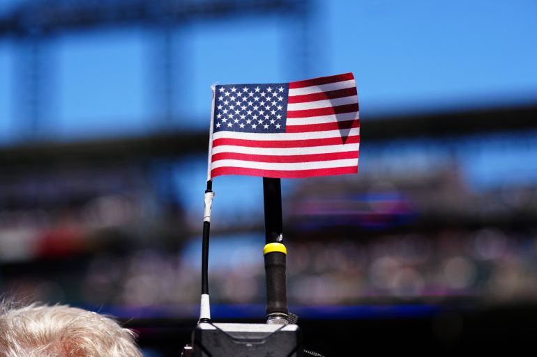 reuters_6a7187b3-1785825203 Jun 11, 2026; Denver, Colorado, USA; Detailed view of the United States of America flag on the top of a broadcast camera refer the game between the Chicago Cubs against the Colorado Rockies at Coors Field. Mandatory Credit: Ron Chenoy-Imagn Images