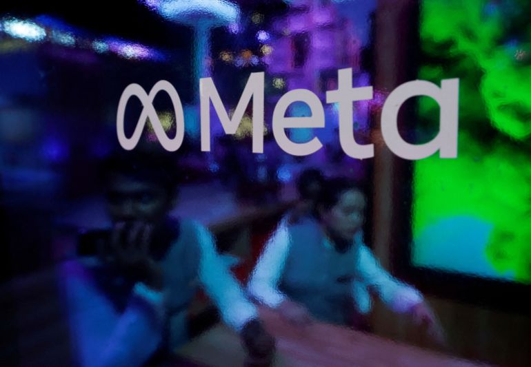 reuters_6a75c39a-1786102682 FILE PHOTO: People are seen behind a logo of Meta Platforms, during a conference in Mumbai, India, September 20, 2023. REUTERS/Francis Mascarenhas/File Photo