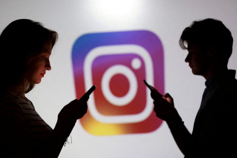 reuters_6a75c3fb-1786102779 FILE PHOTO: Teenagers pose for a photo while holding smartphones in front of an Instagram logo in this illustration created on September 11, 2025. REUTERS/Dado Ruvic/Illustration/File Photo
