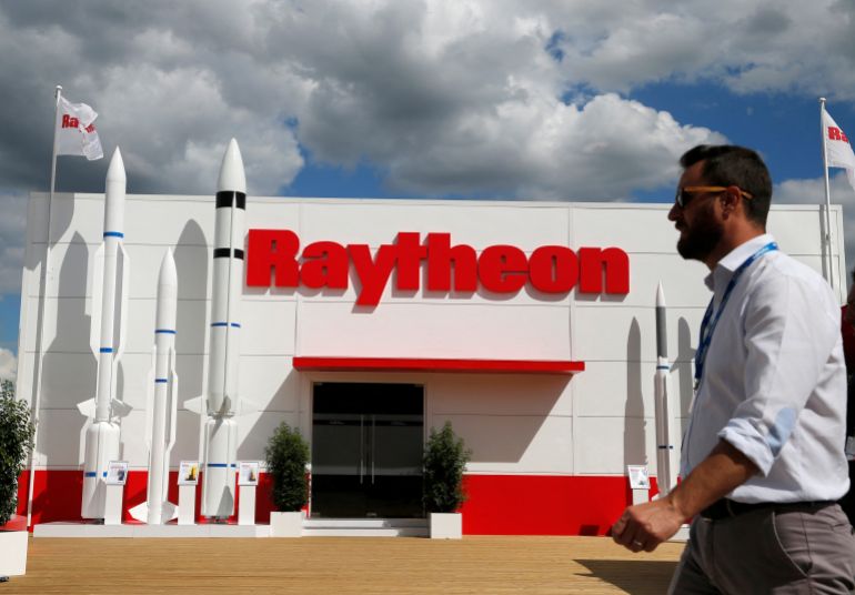 FILE PHOTO: A visitor walks past Raytheon stand at the 53rd International Paris Air Show at Le Bourget Airport near Paris, France June 21, 2019. REUTERS/Pascal Rossignol/File Photo