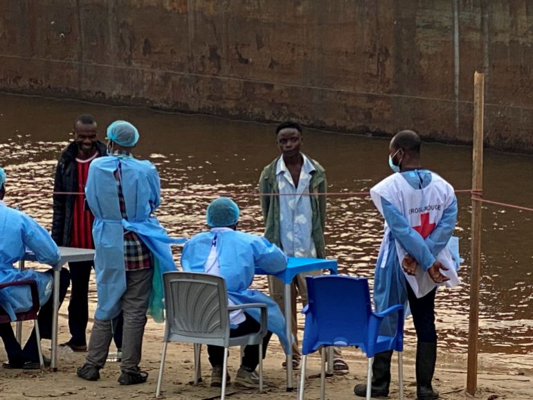 reuters_6a846a14-1787062804 FILE PHOTO: Passengers who disembarked from a boat intercepted by health authorities wait to be tested following the death of a passenger suspected of having Ebola, in Kinshasa, Democratic Republic of the Congo, August 6, 2026. Authorities said the passenger had disembarked earlier in the city. REUTERS/Benoit Nyemba/File Photo