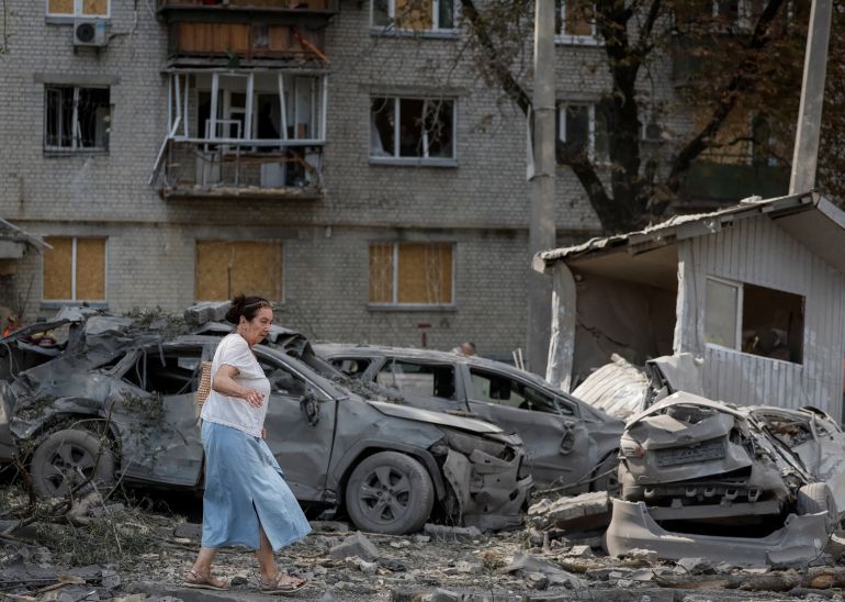 A woman walks at a site of yesterday's missile strike, amid Russia's attack on Ukraine, in Kyiv, Ukraine August 21, 2026. REUTERS/Gleb Garanich